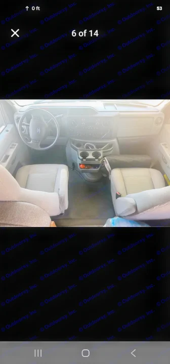 RV rental: Inside a Ford van, showing the driver's cockpit with steering wheel, dashboard, center console with cupholders, and two front seats.. Thor Majestic 2017