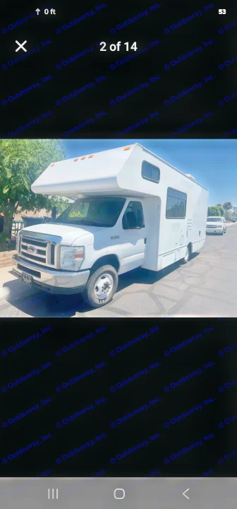 White Ford E-series Class C RV rental, a motorhome parked on a sunny street, ready for your next adventure.. Thor Majestic 2017