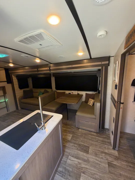 Spacious RV rental interior featuring a modern kitchen, comfortable dinette, and inviting living area.. Crossroads RV Sunset Trail Super Lite 2021
