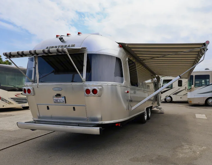 This iconic Airstream travel trailer with extended awnings, ideal as an RV rental option for your next adventure.. Airstream Classic 2019