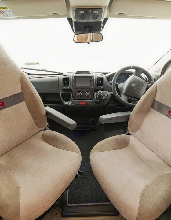 Spacious RV rental front cabin interior. View of driver and passenger seats, dashboard, and steering wheel, ready for your road trip.. Elddis Whirlwind GT 185 2026