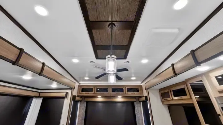 RV rental's contemporary interior features a bright ceiling with a modern fan, recessed lights, and decorative wood trim.. Crossroads RV Cameo 2022