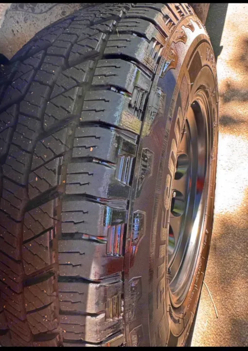 Close-up of a durable RV rental tire with deep tread and black rim, ready for adventure.. Chevrolet Open Road 2005