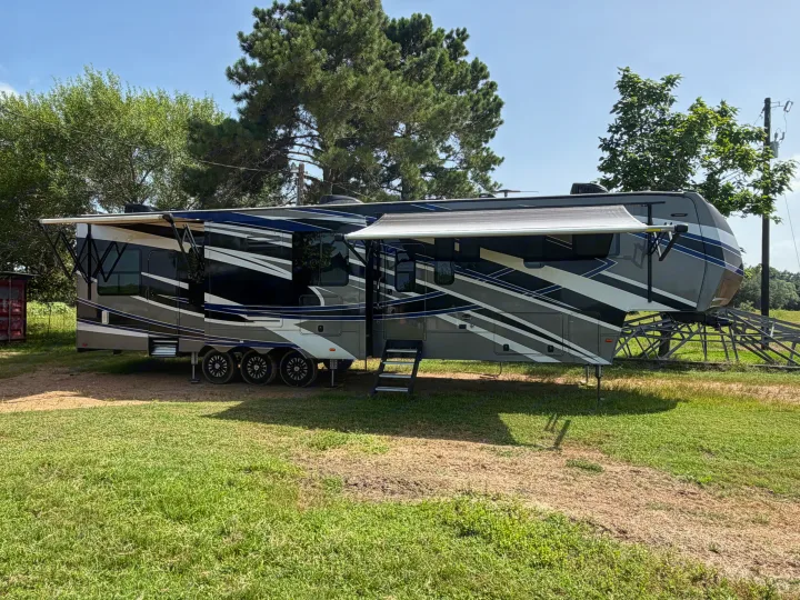 Spacious fifth-wheel RV rental with extended slide-outs and deployed awnings, ready for your camping adventures.. Denali Denali Fifth Wheel 2017