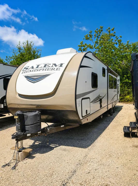 Explore the outdoors in this beige and white Forest River Salem Hemisphere travel trailer, perfect for your next RV rental.. Forest River Salem 2021