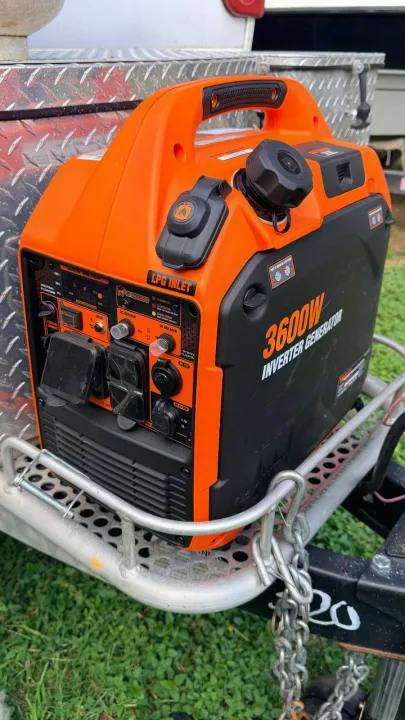 This orange and black 3600W inverter generator, ideal for an RV rental, provides portable power on adventures.. nuCamp T@B 2022