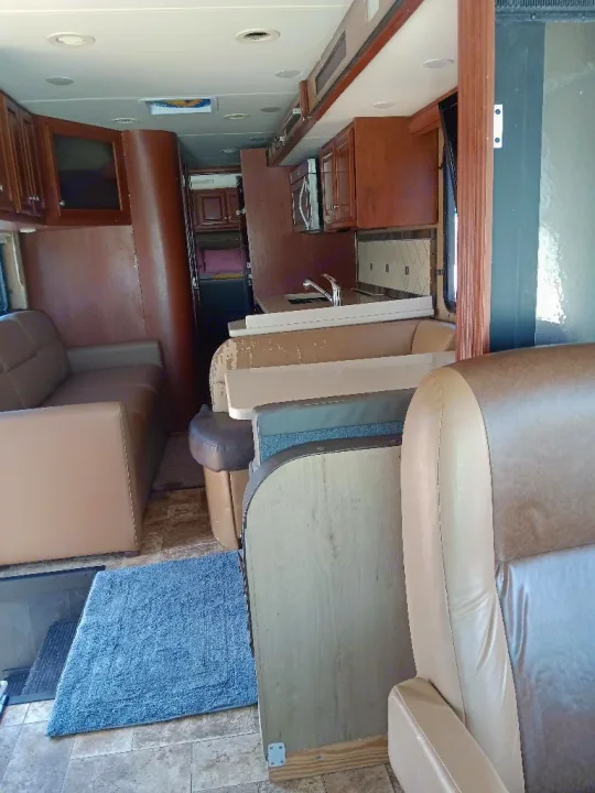 Spacious RV rental interior featuring a modern living area, fully equipped kitchen, and comfortable seating.. Thor Palazzo 2014
