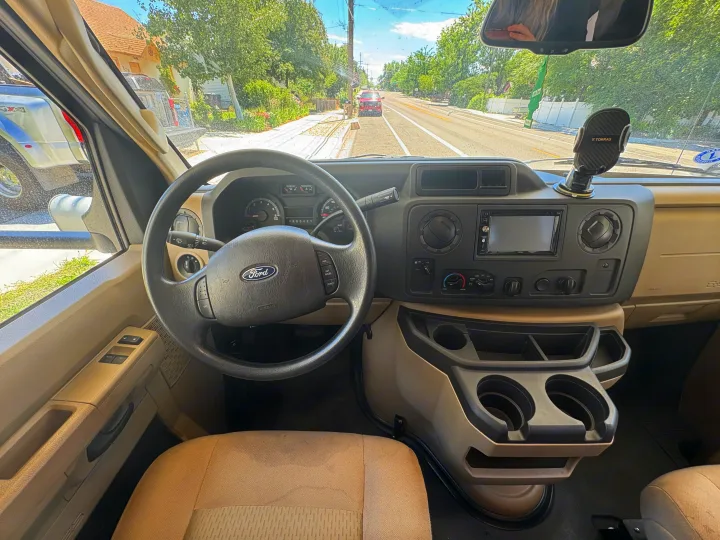 Interior of an RV rental, featuring the Ford dashboard, steering wheel, and a clear view of the road ahead.. Coachmen Freelander 2018