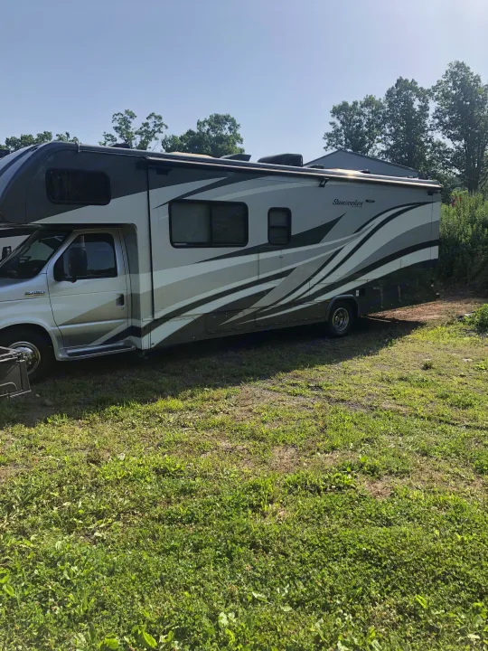This Sunseeker RV rental, a Class C motorhome, is parked outdoors on grass under a clear sky.. Forest River Sunseeker 2017