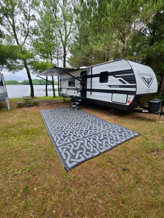 Lakeside **rv rental**: Grand Design travel trailer with extended awning, picnic table & outdoor mat on grass.. Grand Design RV Transcend Xplor 26BHX 2027