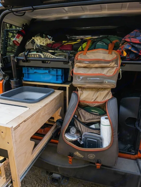 Organized SUV camping setup with a wooden pull-out kitchen & Kelty gear bag. Ideal for your next rv rental trip!. Jeep Wrangler 2012