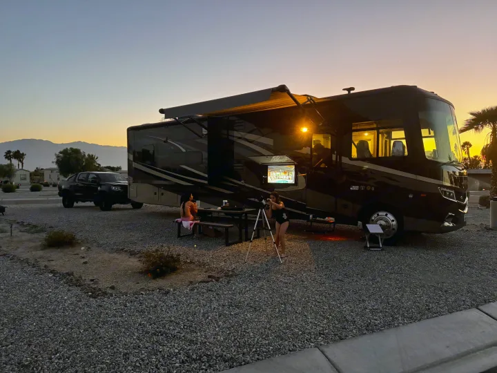 An RV rental provides a cozy desert campsite at sunset, with an outdoor movie and stargazing.. Jayco Precept 2019