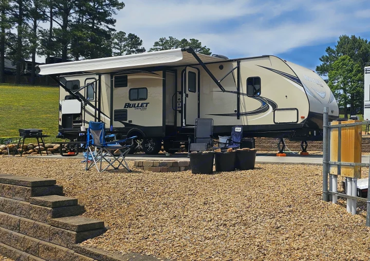 Enjoy this spacious Bullet Ultra Lite RV rental at a sunny campsite, complete with chairs, grill, and a fire pit for outdoor fun.. Keystone RV Bullet Ultra Lite 2018