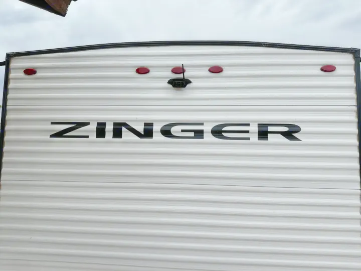 Rear of a white Zinger RV rental, featuring a backup camera and tail lights. Perfect for your next adventure.. Crossroads RV Zinger Lite 2026