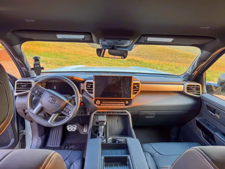 View inside a modern car: dashboard, large screen, steering wheel. Ideal car for an RV rental journey.. Toyota Tundra 2026