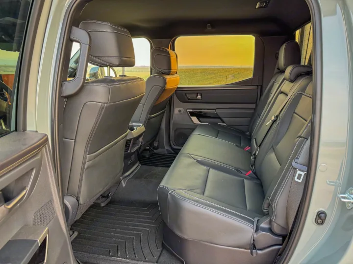 Detailed view of a truck's spacious back seats, featuring leather & all-weather mats, perfect for an RV rental trip.. Toyota Tundra 2026