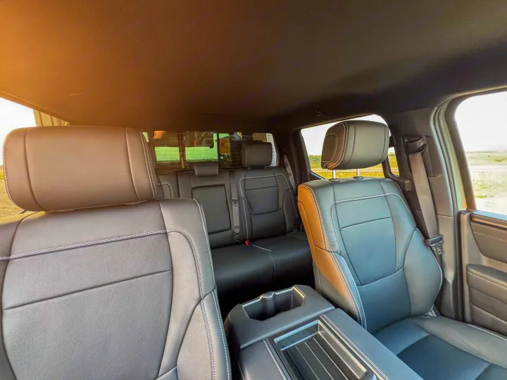 Spacious vehicle interior: black leather rear seats with white stitching, cup holder console. Great for your RV rental trip.. Toyota Tundra 2026