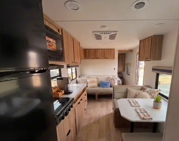 Explore the comfortable interior of this rv rental, with a well-equipped kitchen, inviting dining nook, and relaxing lounge.. Winnebago Access 2025