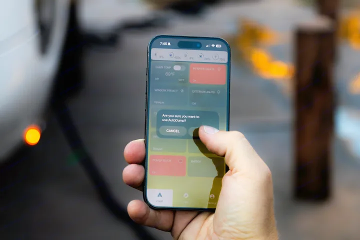 Hand taps smartphone app to control rv rental features like lights, temp, and confirm 'AutoDump' settings.. Pebble Flow 2026