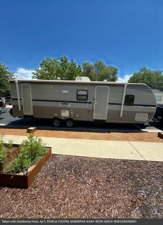 Shasta travel trailer rv rental with open doors, parked outdoors on a sunny day, ready for your next adventure.. Forest River Shasta 2021