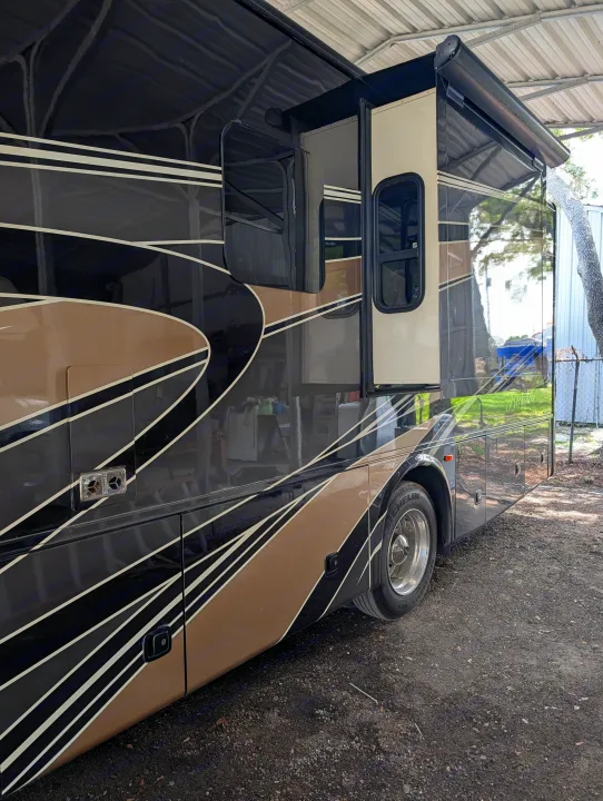 Explore in style with this luxurious RV rental, featuring a sleek black and tan exterior and extended slide-out.. Forest River Berkshire 2018