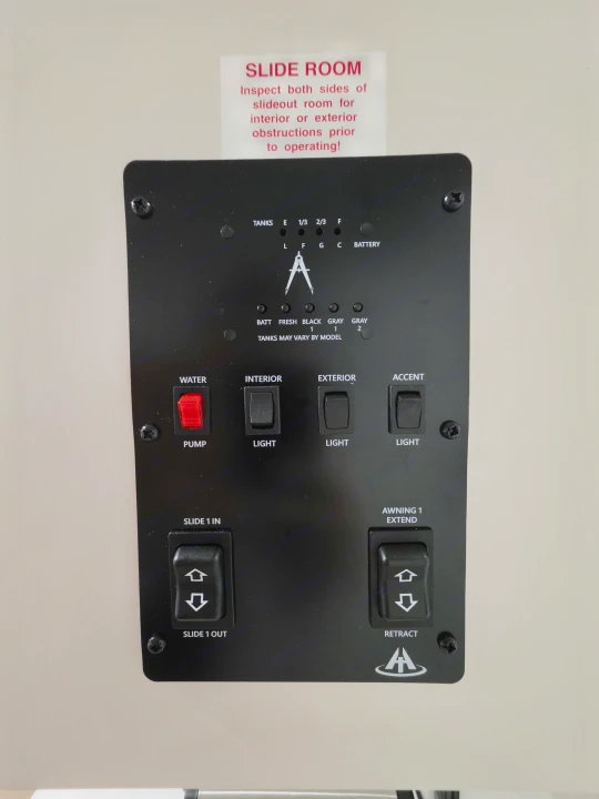 RV rental control panel: Monitor tanks, battery, and operate water pump, lights, slide room, and awning.. Grand Design Transcend Xplor 26BHX 2027