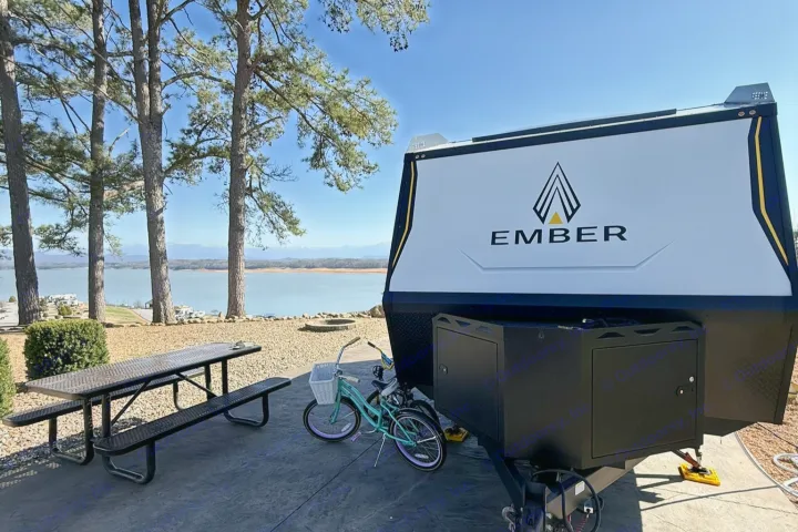 Ember travel trailer RV rental with scenic lake & mountain views, picnic table, and bike. Perfect for outdoor adventures!. Ember Overland 2023