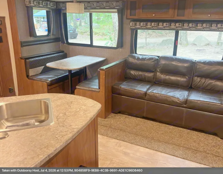 Cozy RV rental interior with dinette, sofa, and kitchen sink, perfect for camping adventures.. Heartland RVs Pioneer 2018
