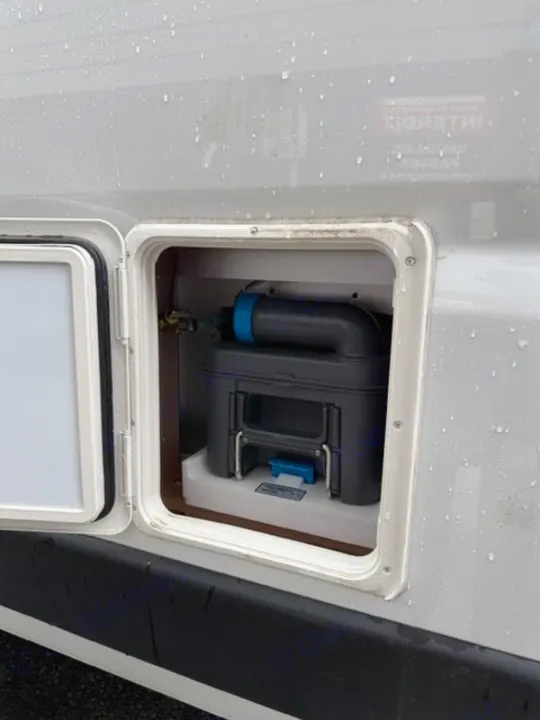 RV rental's side panel open, revealing the cassette toilet waste tank for convenient emptying.. Safari Safari 2025
