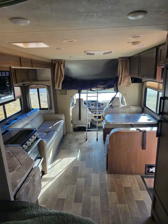 Spacious rv rental interior with kitchen, living space, dinette, and overhead bunk bed, ready for your adventure.. Thor Chateau 2021