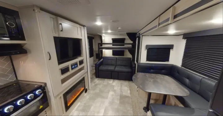 Spacious, modern rv rental with kitchen, dining booth, sofa, entertainment center, and bunk beds.. Coachmen Apex 2022