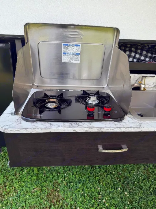 This rv rental features a convenient outdoor kitchen with a two-burner stove, sink, and marble counter for camping cooking.. Jayco Jay Flight 2021
