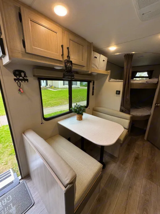 RV rental: inviting dinette with a window view, overhead storage, and cozy bunk beds in a modern interior.. Coachmen Catalina Summit Series 8 2026