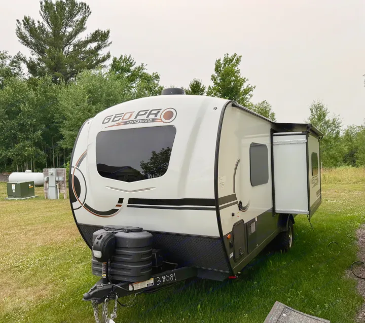 Geo Pro by Rockwood travel trailer, an ideal rv rental. This camper is set up outdoors with its slide-out extended.. Forest River Rockwood Geo Pro 2025