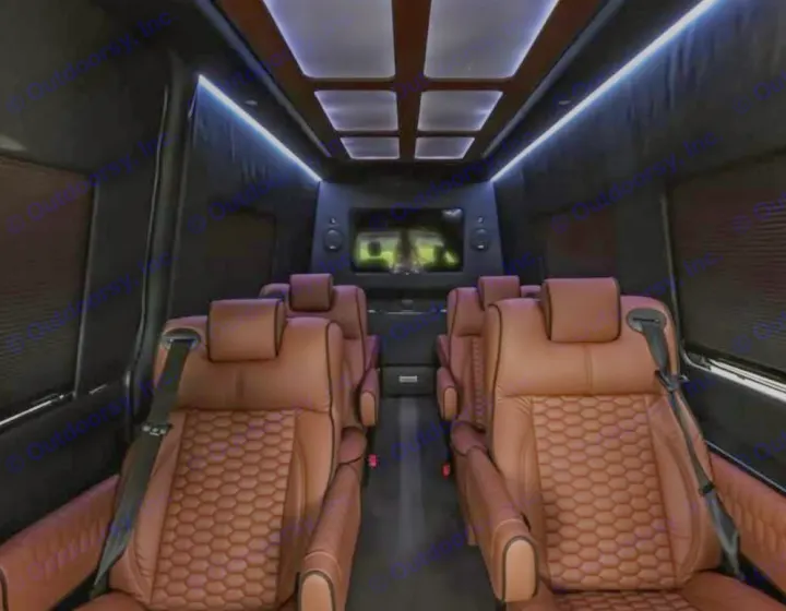 Luxurious RV rental interior with comfortable brown leather seating, ambient lighting, and a TV screen for premium travel.. Mercedes Benz Executive Lounger by Legends Sprinter 3500xd 170 Ext AWD Executive Lounger 2023