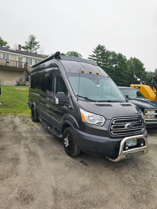 Dark gray Ford Transit rv rental camper van, custom-built for adventure. Features awning & bull bar.. Forest River Coachmen Crossfit 2018