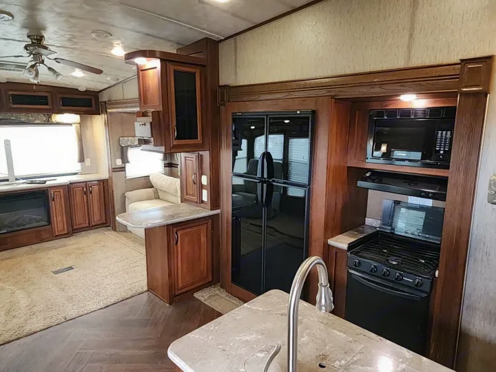 Explore this comfortable RV rental interior, featuring a well-appointed kitchen, modern appliances, and a relaxing living space.. Forest River SABRE 2015