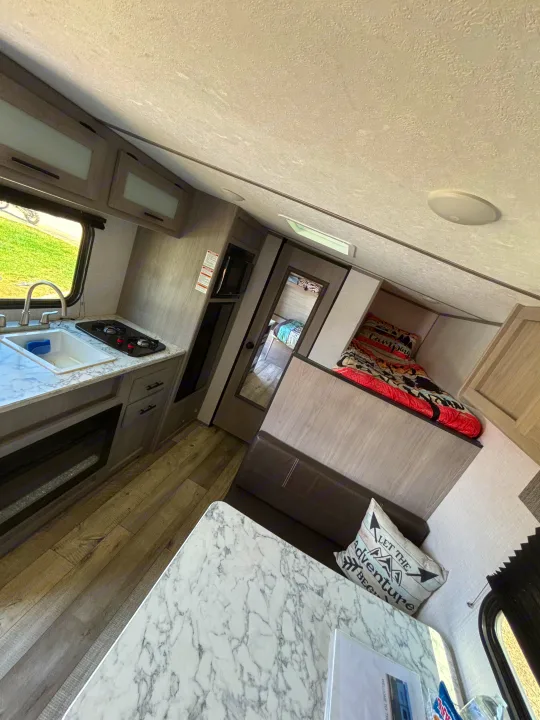 Experience comfort in this rv rental! Features a full kitchen, dining nook, and cozy sleeping area for travelers.. Dutchmen Coleman Lantern LT 2023