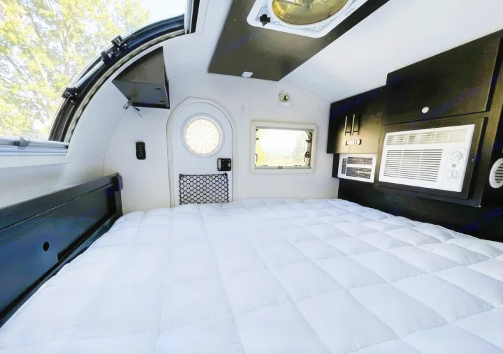 RV rental interior: A large, comfortable bed, multiple windows, and dual AC units provide comfort in this compact teardrop camper.. nuCamp T@G 2022