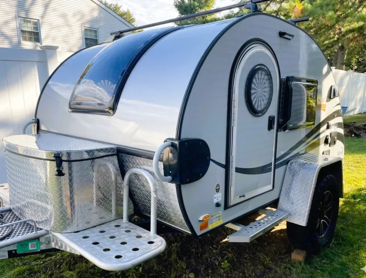 A sleek, gray teardrop RV rental with a front storage box and off-road tires, ready for your next camping adventure.. nuCamp T@G 2022