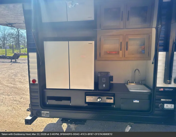 RV rental featuring an outdoor kitchen: Furrion fridge, sink, Greystone grill, and cabinets for convenient camping.. Forest River Cherokee Grey Wolf 2026
