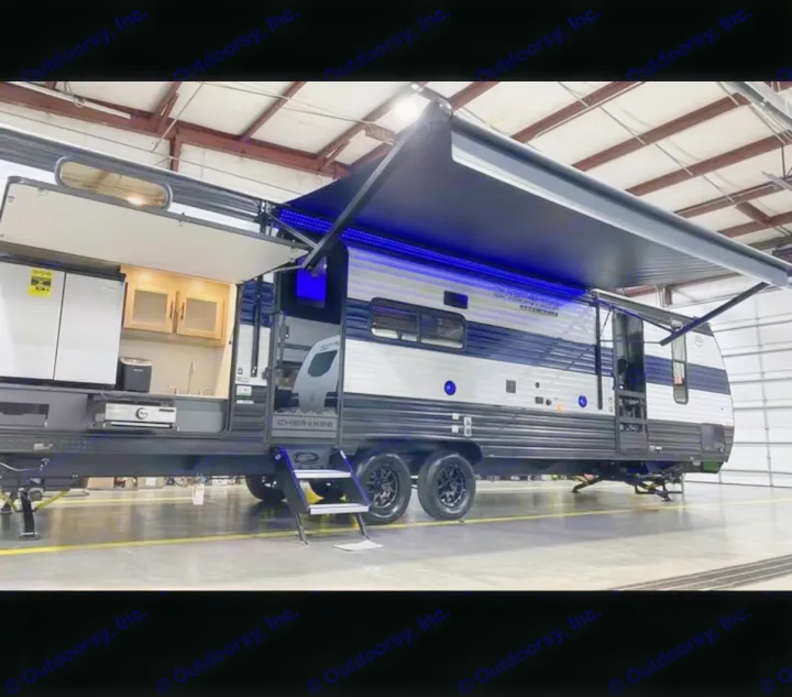 Explore this RV rental featuring an outdoor kitchen, extended awning with blue LED lights, and convenient entry steps.. Forest River Cherokee Grey Wolf 2026