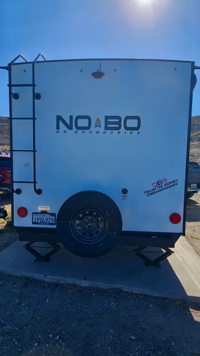 Explore with this No Boundaries rv rental, featuring a rear ladder, spare tire, and stabilizer jacks for your camping trip.. No Boundaries 19 2022