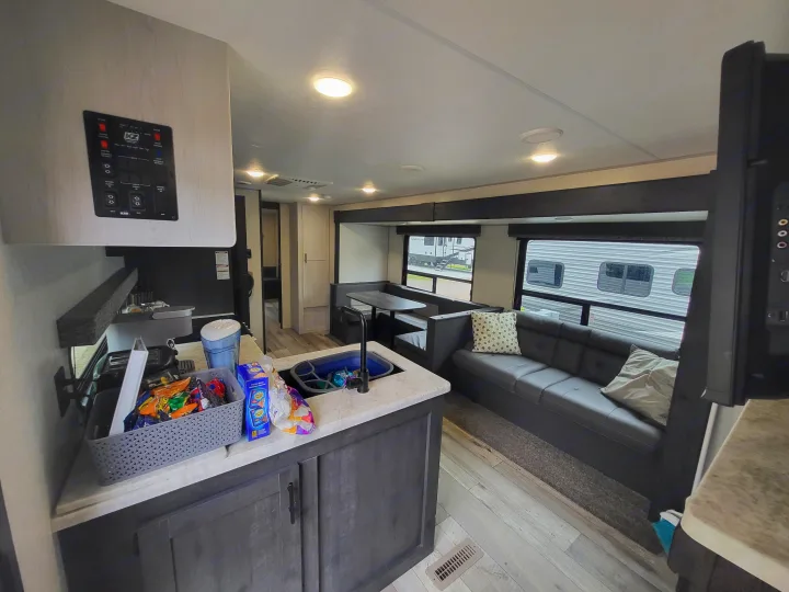 Spacious rv rental interior featuring a modern kitchen, dining area, and comfortable sofa, perfect for travel.. KZ Sportsmen SE 332bkhse 2022