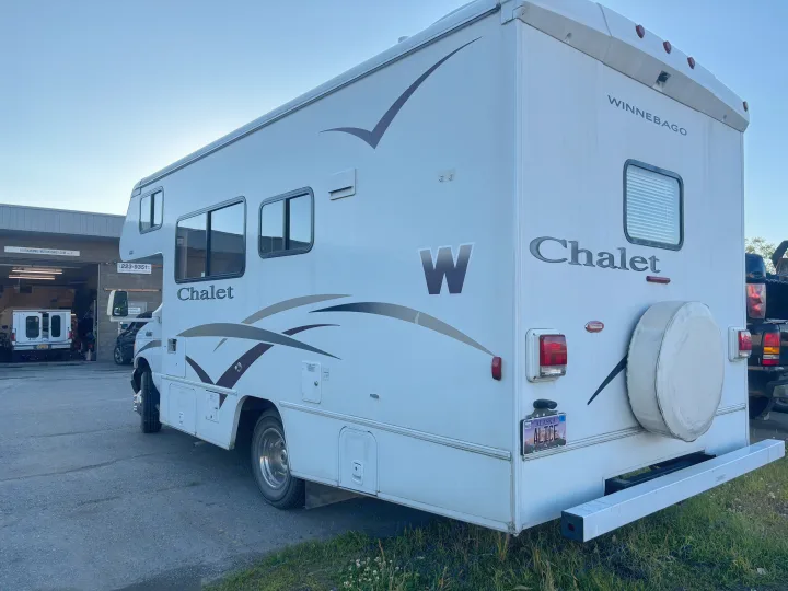A white Winnebago Chalet Class C motorhome, an Alaskan rv rental, parked at AlaskaFamilyMotorhomes for service or pickup.. Winnebago Chalet 2007