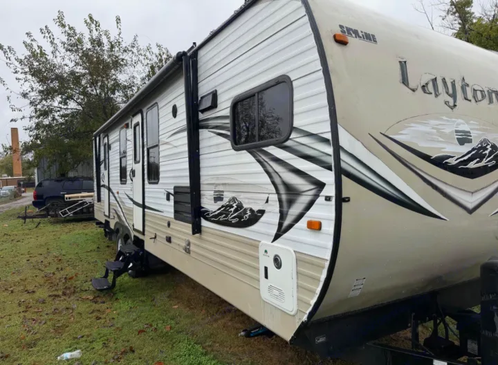 This Skyline Layton travel trailer RV rental is parked on grass, ready for your next outdoor adventure.. Layton Layton Trailer 2014