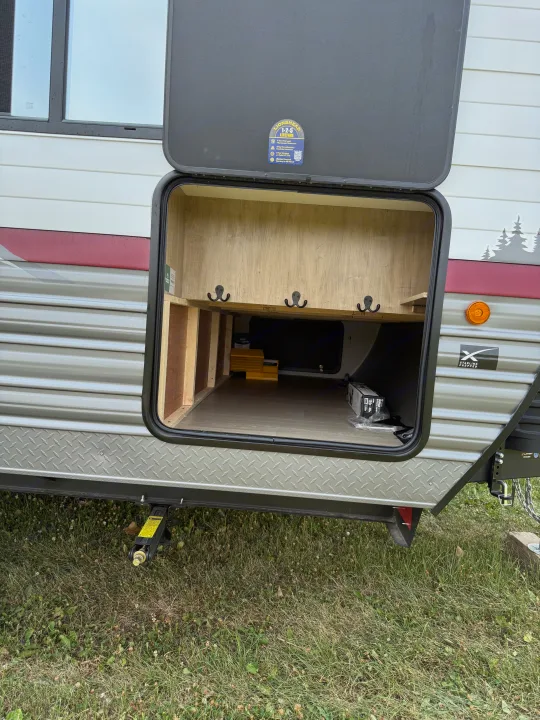 RV rental: Open pass-through storage with interior hooks, an inverter, and exterior 'Starlink Prepped' and 'Lionshead' decals.. Forest river Campsite Reserve 26cj 2027