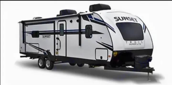 Explore in style with this white Sunset Trail travel trailer RV rental, featuring blue accents & twin axles.. Crossroads RV Sunset Trail 2022