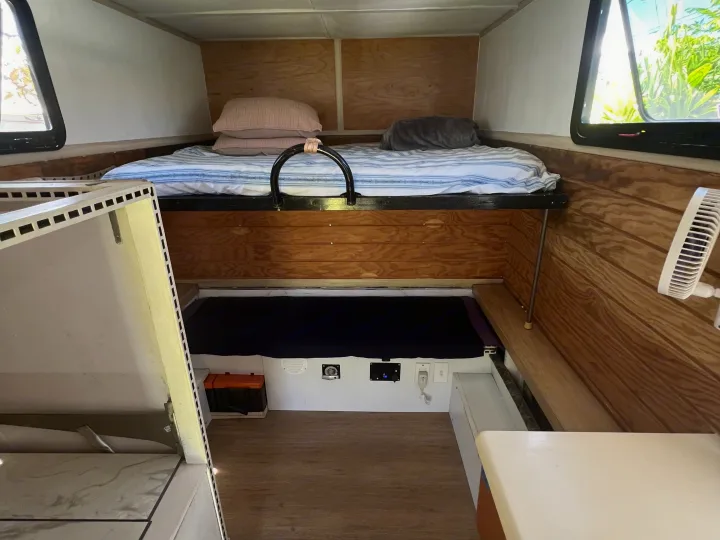 Cozy RV rental interior featuring bunk beds, wooden paneling, and accessible power outlets for a comfortable stay.. Ford Ford F150 2019