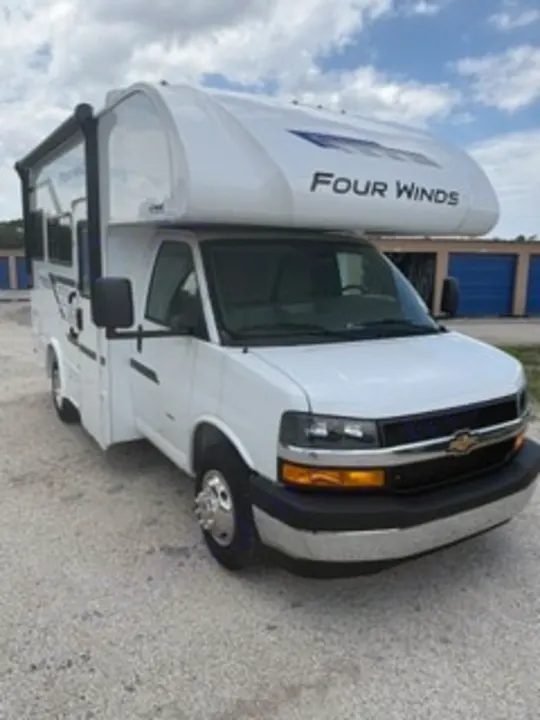 White Four Winds Class C RV rental, a compact motorhome, parked outdoors, ready for your next travel adventure.. Thor Four Winds 2026